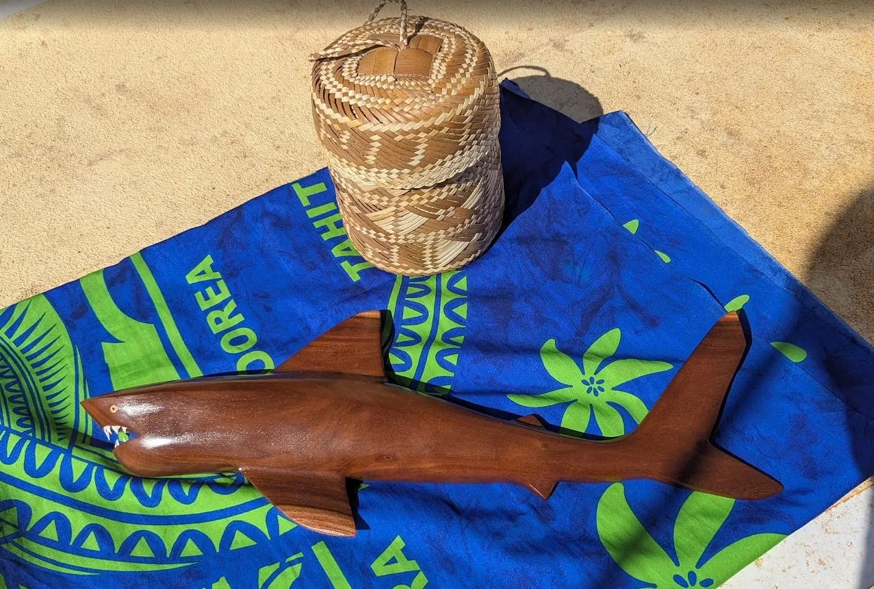 Pitcairn islander hand-carving a figure from miro wood in the traditional craft