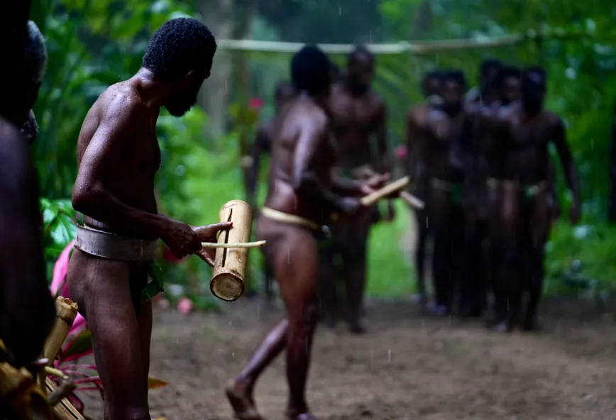Banam Bay villagers performing a kastom dance in traditional namba dress