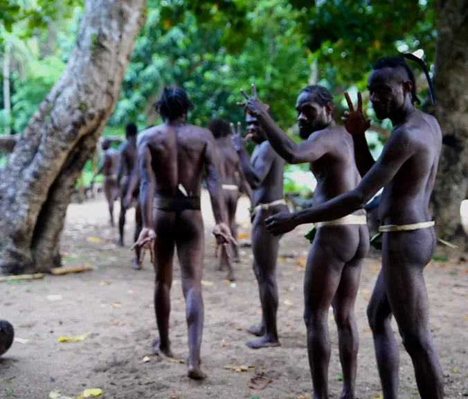 Older men playing bamboo slit drums for the kastom dance in Banam Bay