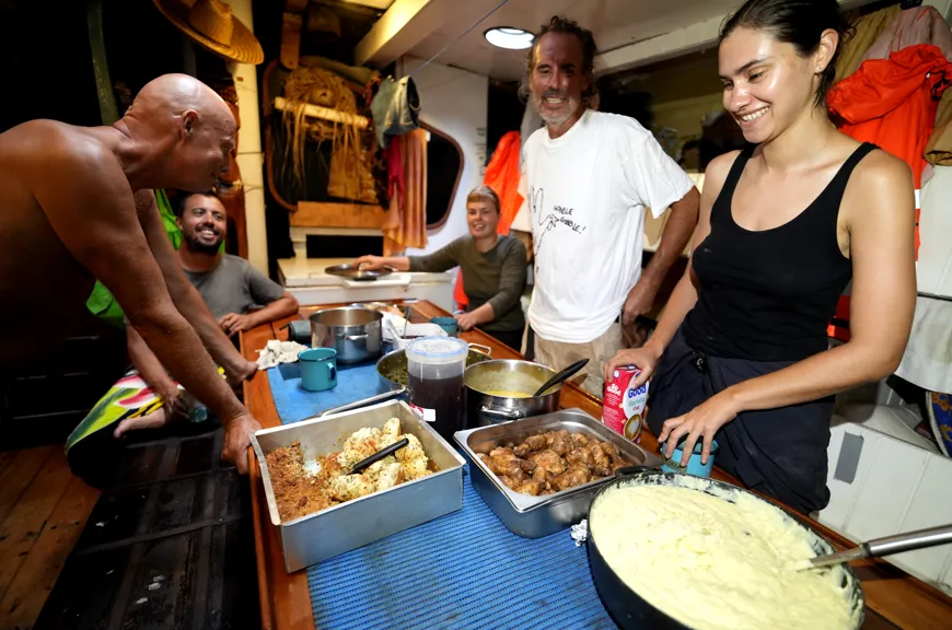 Crew sharing the American Thanksgiving feast at the salon table aboard NEPTUN