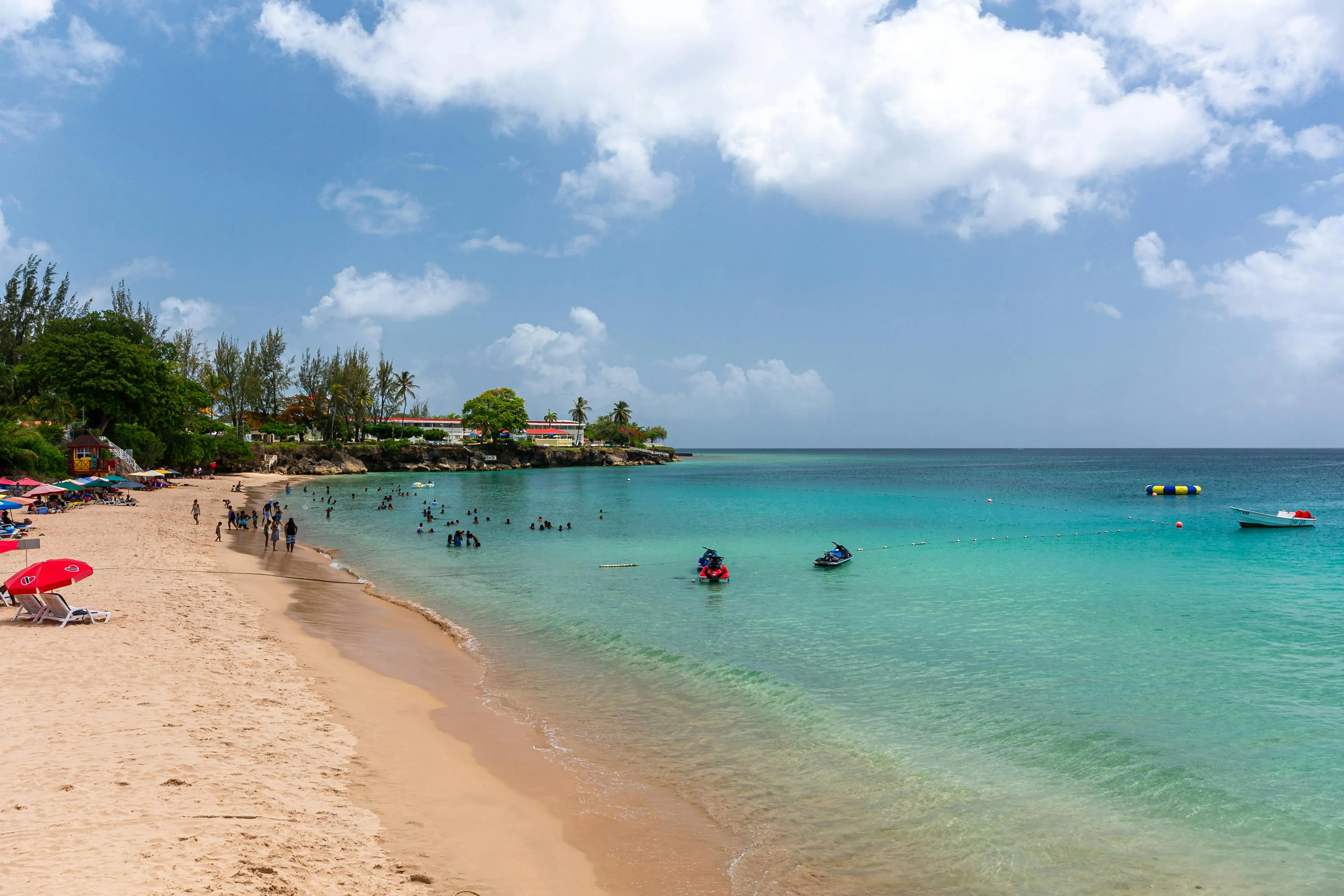 The Caribbean announces itself, turquoise water, palms, and the first real warm-water landfall after three thousand miles of Atlantic.