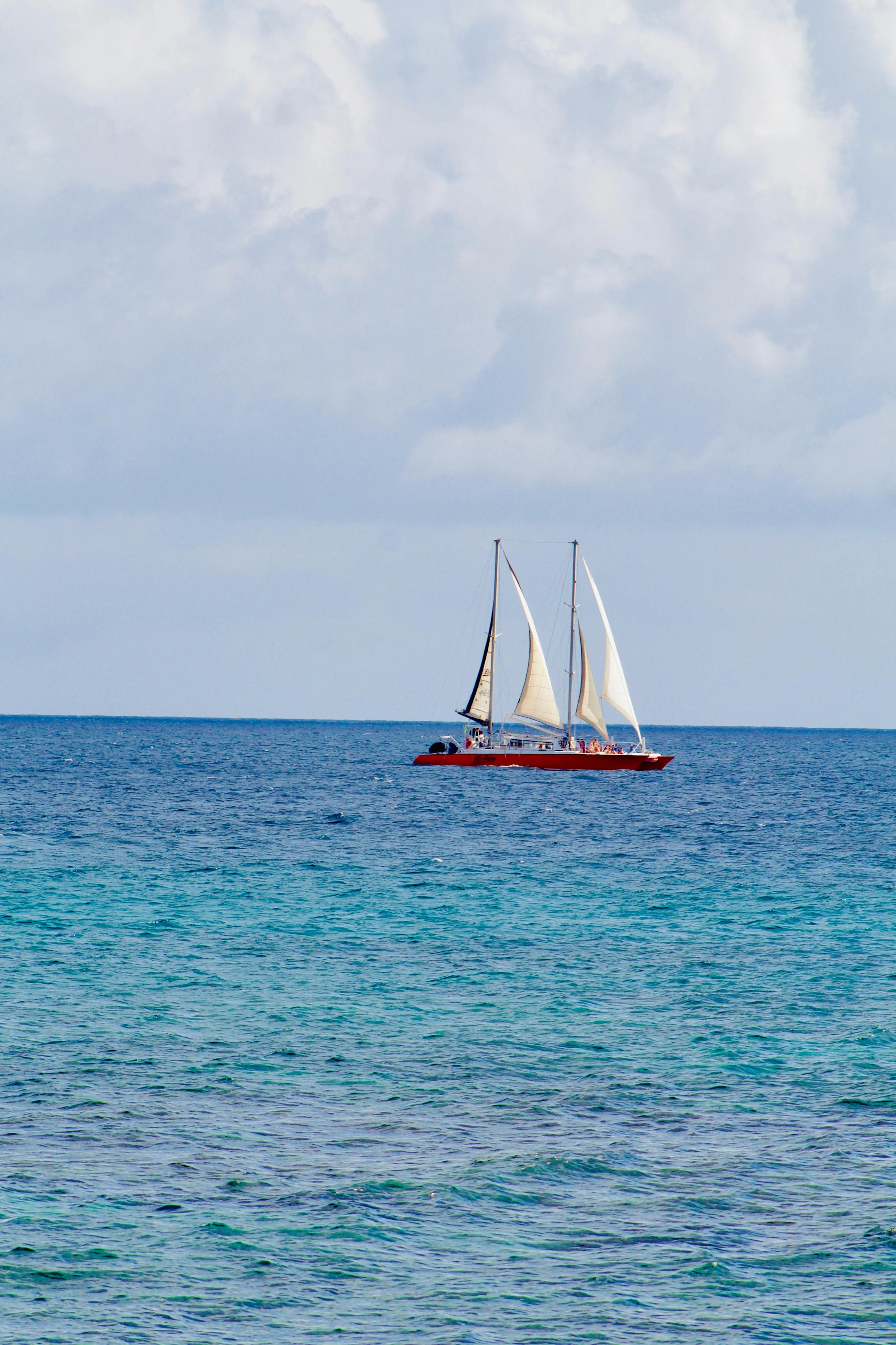 A yacht under sail in the Grenadines, trade-wind reaches between small volcanic islands, day after day.