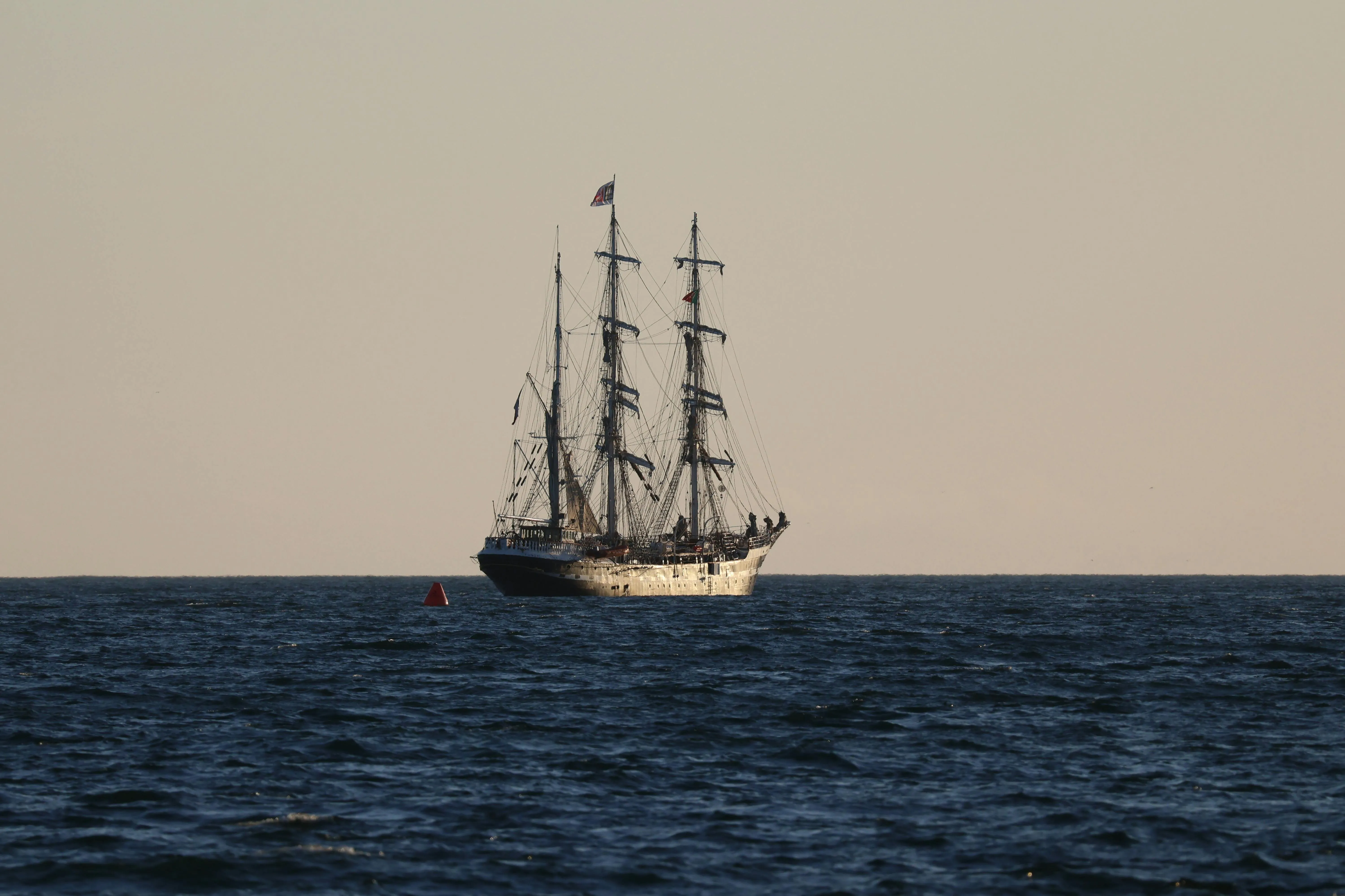 A tall ship on the open sea under squares, the image of NEPTUN on her last Atlantic passage.