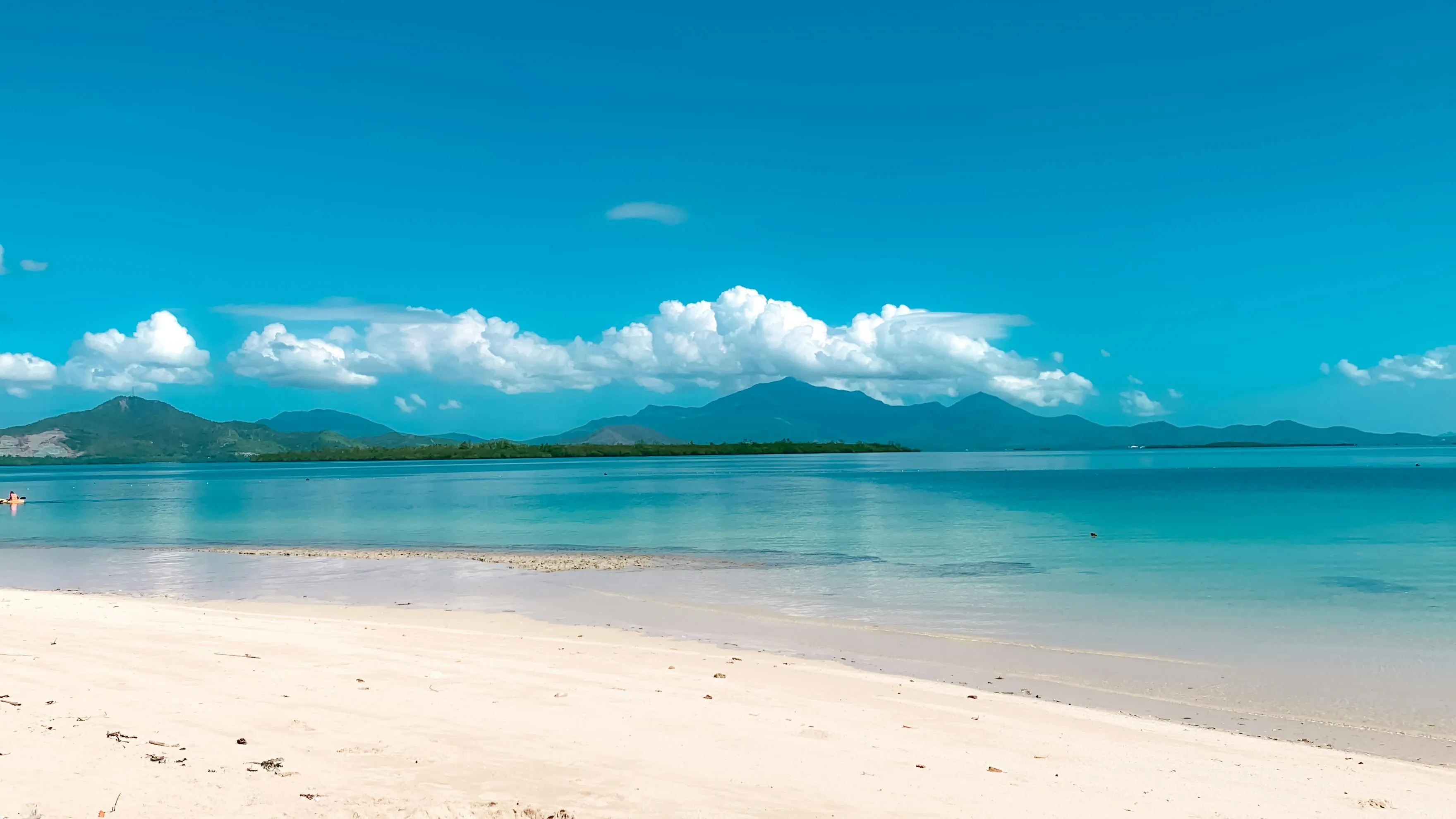 White sand and coral-clear water off Carriacou, the kind of anchorage you row ashore to just for the walk.