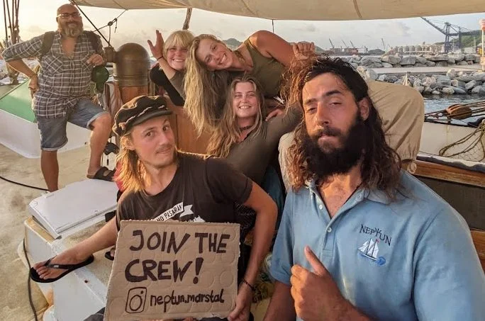 NEPTUN crew holding a JOIN THE CREW sign