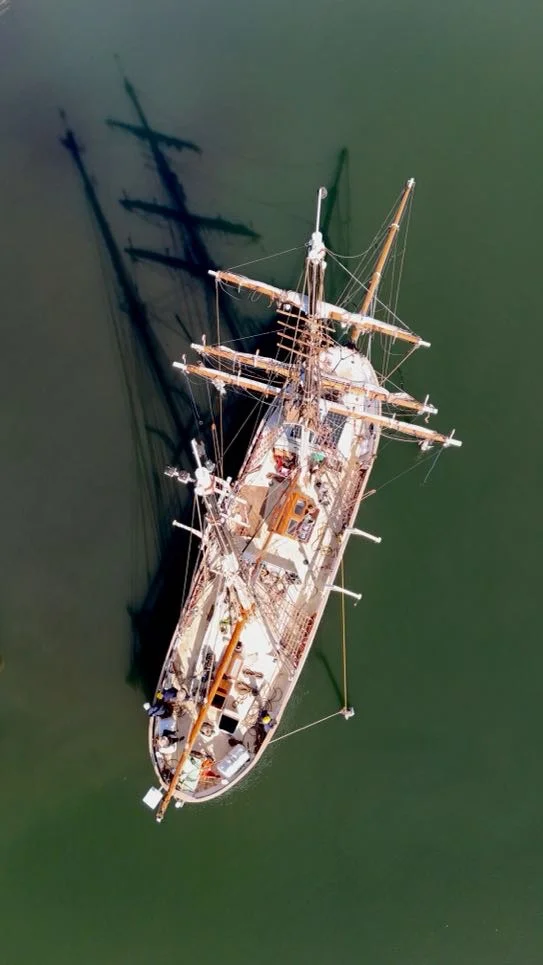 Aerial drone view of the Brigantine NEPTUN sailing on deep-blue ocean