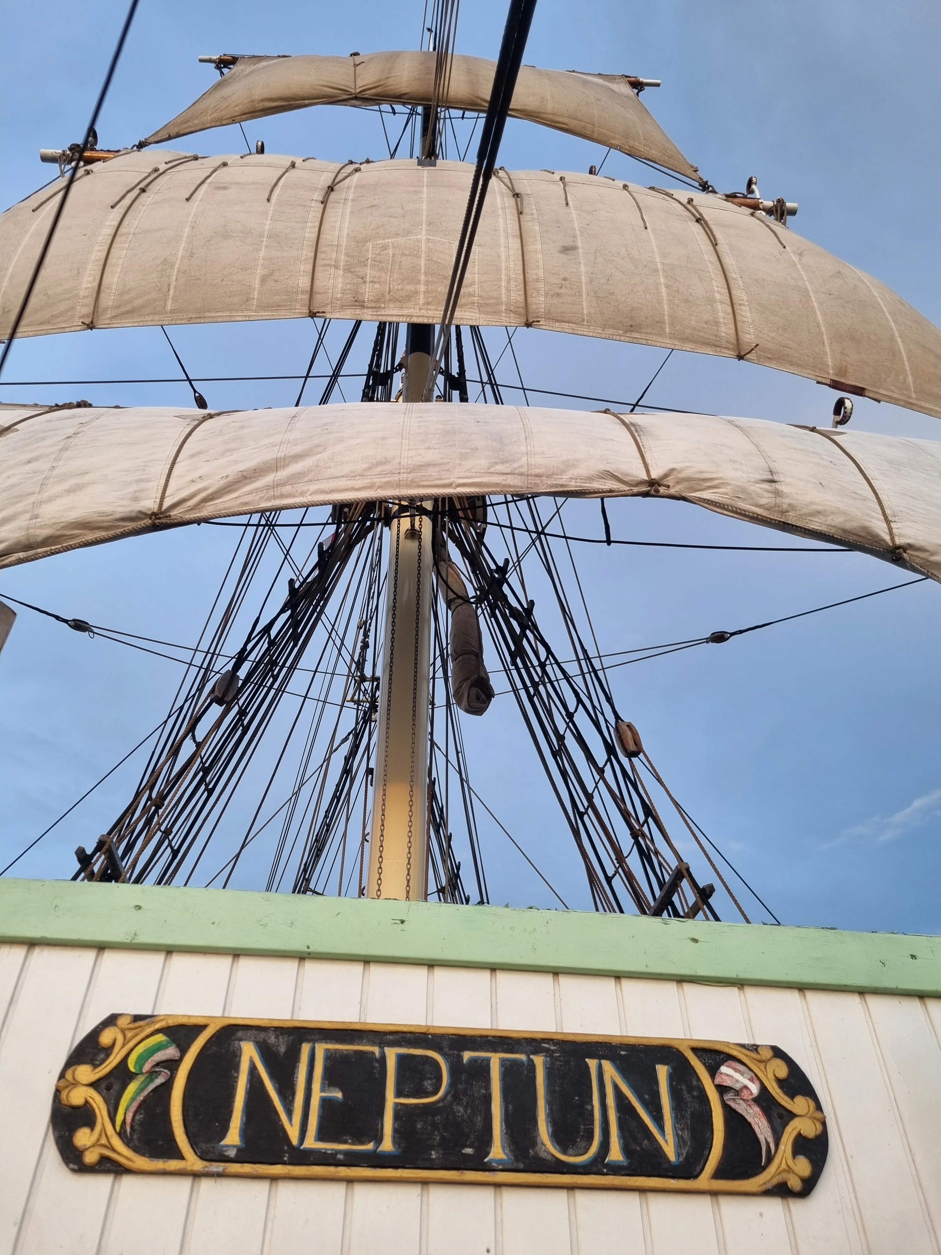 NEPTUN nameplate on the deckhouse with sails set above