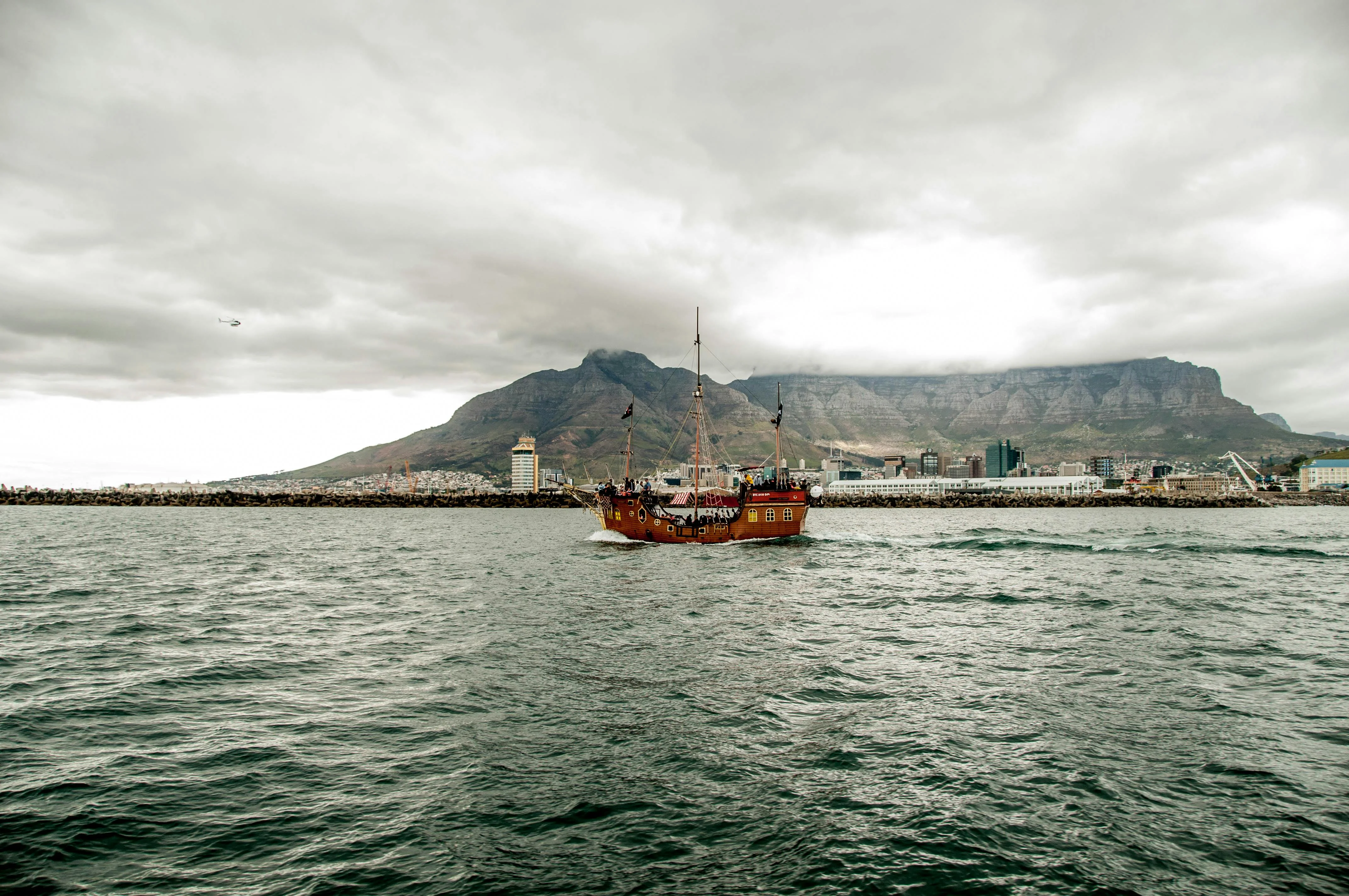 Square-rigger under sail with Table Mountain astern, the classic Cape Town arrival.