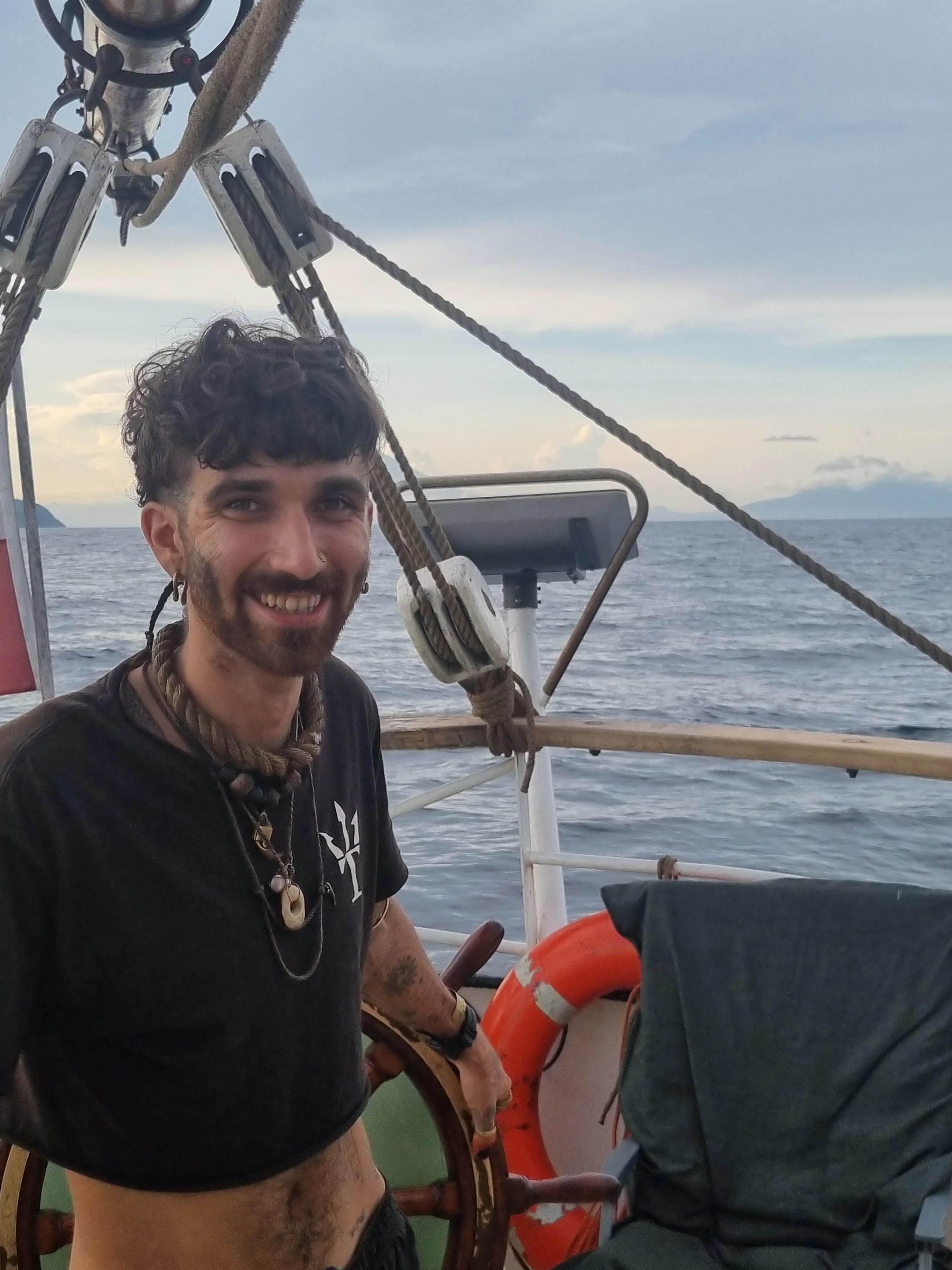 Helmsman steering Brigantine NEPTUN at the wheel
