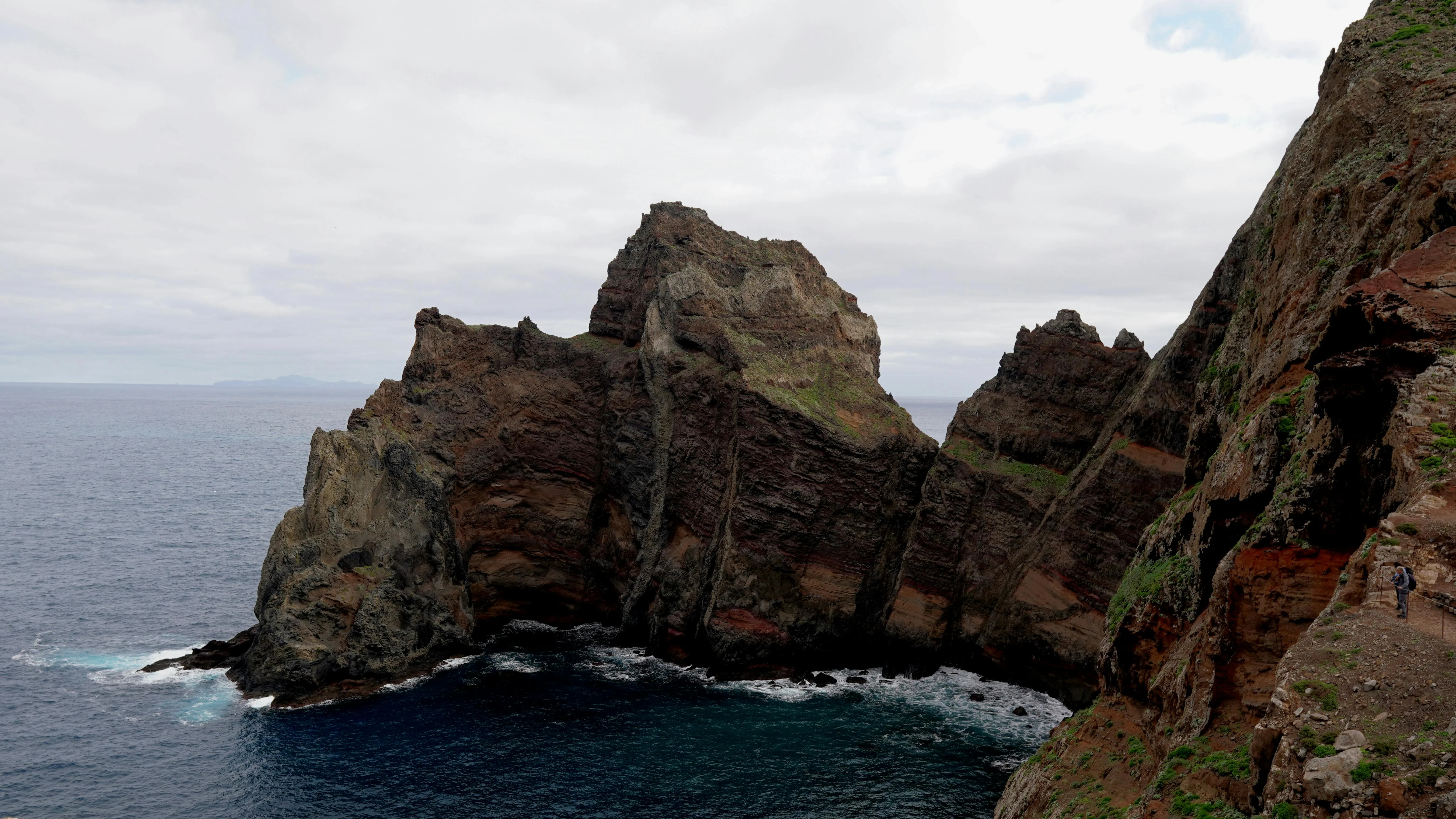 Dramatic volcanic cliffs rising sheer from the Atlantic, the same shape that greets the crew when Saint Helena lifts over the bow.