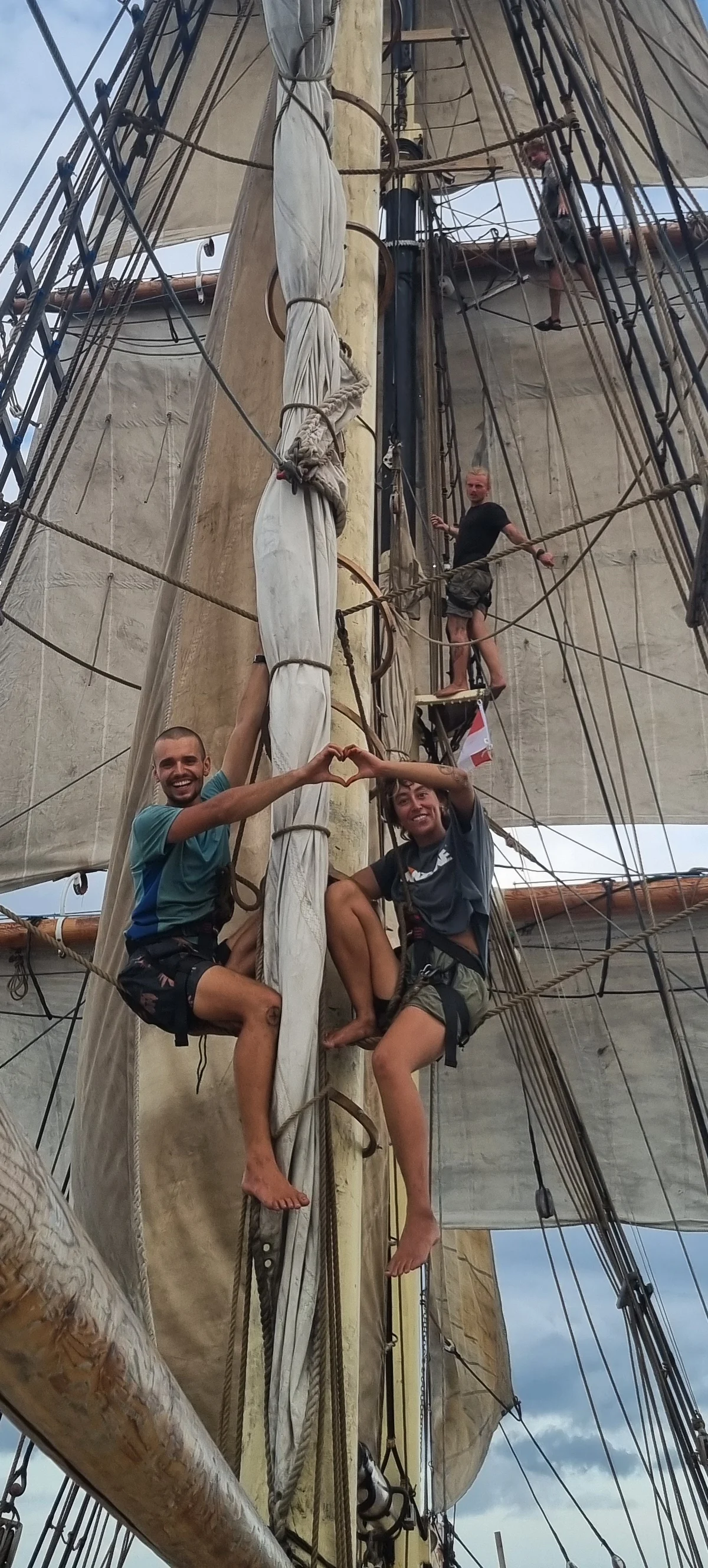 Crew working in the rig under square sails